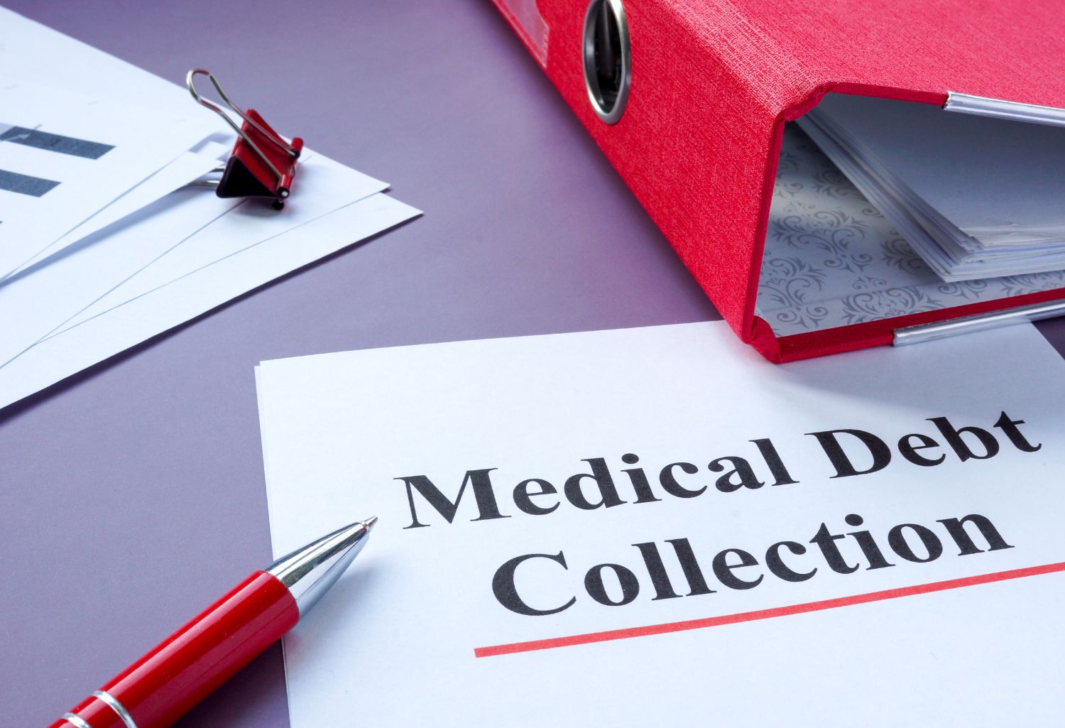 Medical debt collection papers and red folder.